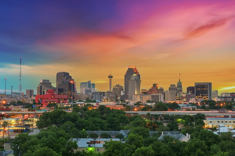 San Antonio skyline beneath a colorful sunset