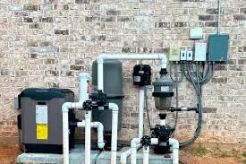 Pool equipment and controls mounted beside a brick wall