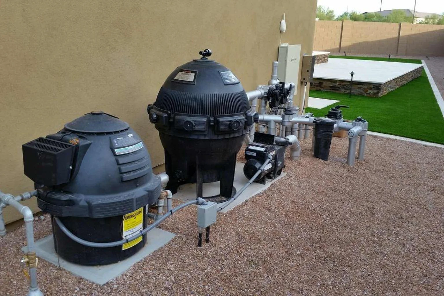 Pool equipment pad with a heater, filter, pump, and connecting plumbing